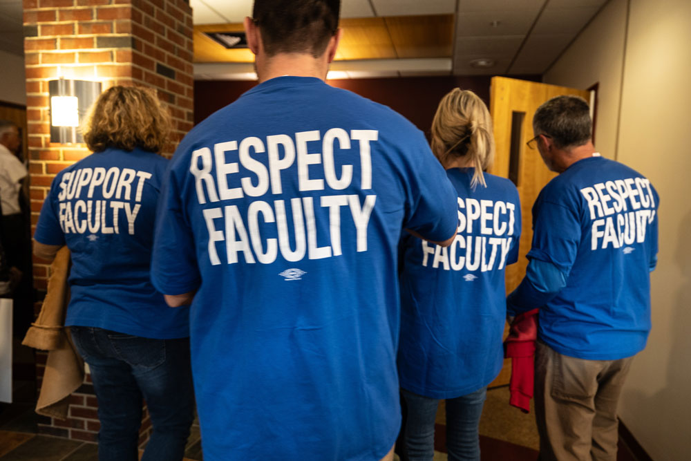 Group wearing blue shirts with Respect Faculty and Support Faculty text by IBEW Local 2320